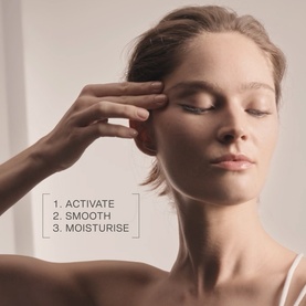 Model applying La Prairie Skin Caviar Liquid Lift serum to temple area, eyes closed, with on-image text: Activate, Smooth, Moisturise