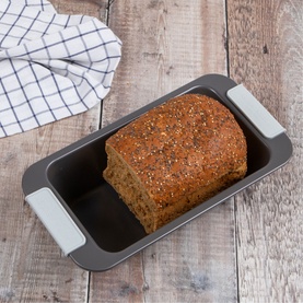 Laura Ashley Loaf Pan Tin 900g in charcoal carbon steel with silicone handles, shown with a freshly baked seeded loaf inside