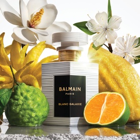 Balmain Blanc Galaxie Eau de Parfum in ribbed glass bottle with gold cap, styled with magnolia, citrus fruits and white flowers