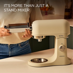 Kenwood kMix Calm Cream Stand Mixer in use with pasta roller attachment, shown on kitchen counter