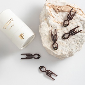 Fiona Franchimon N&ordm;1 Hairpin Petite in Brown, set of small dark brown decorative hair clips shown with branded cylinder case on stone prop