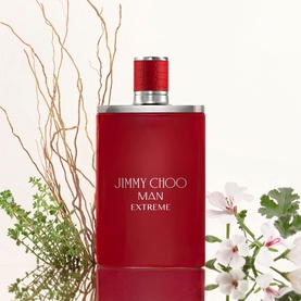 Jimmy Choo Man Extreme Eau de Parfum 50ml in red bottle with red cap, styled with botanical foliage and white flowers