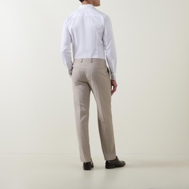 Model wearing Strellson Melvin Slim Fit Suit Trousers in beige, rear view, styled with a white dress shirt and dark shoes