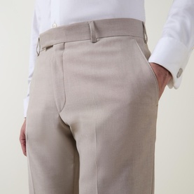 Model wearing Strellson Melvin Slim Fit Suit Trousers in beige, with pressed creases and belt loops, styled with a white shirt