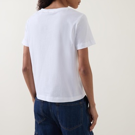 Model wearing Gant Shield Logo T-shirt in white, back view, short sleeves and straight hemline, styled with dark blue jeans