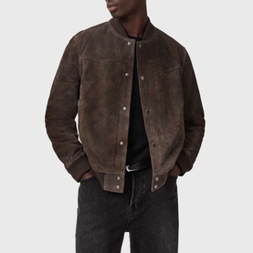 Model wearing All Saints woodland brown suede bomber jacket with snap-button fastening, styled with black T-shirt and dark jeans