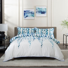 The Lyndon Company Pearls Duvet Set Multi, white cotton bedding with blue cascading dot pattern, styled on a double bed with two pillowcases