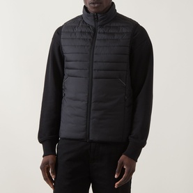 Model wearing Boss Green Label Water Repellent Gilet in black, padded with stand-up collar and full zip, styled with black sweatshirt and trousers