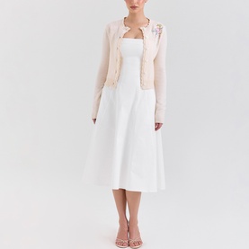 Model wearing House of CB Anjou Knitted Cardigan in Cream Floral with floral embroidery and scallop edges, styled with white midi dress and nude