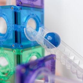 Connetix Rainbow Replacement Balls Pack, clear ball rolling through translucent blue, green and purple magnetic tile run tracks