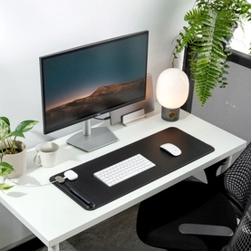 Orbitkey Desk Mat Slim in black faux leather on white desk, styled with monitor, keyboard and mouse, featuring magnetic cable holder