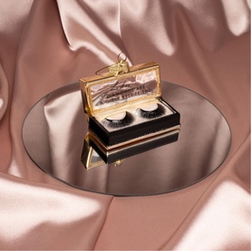 Vondels Fake Lashes Glass Tree Decoration in black, gold glitter box design with logo nameplate and hanging loop, displayed on mirror tray