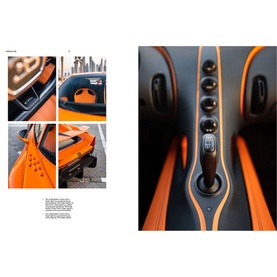 New Mags Iconic Cars book open to spread showing close-up interior photography of an orange and black sports car dashboard and controls