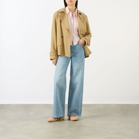 Model wearing Salsa Faith High-Rise Wide Leg Jeans in blue with wide-cut leg, styled with a camel jacket and pink shirt.
