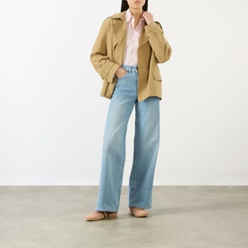 Model wearing Salsa Faith High-Rise Wide Leg Jeans in blue with wide-cut leg, styled with a tan jacket and blush shirt.