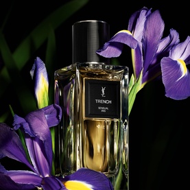 YSL Le Vestiaire des Parfums Trench Eau de Parfum in amber glass bottle with black cap, styled with purple iris flowers