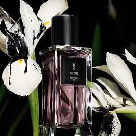 YSL Le Vestiaire des Parfums Muse Eau de Parfum in purple-tinted glass bottle with black cap, styled with white iris flowers