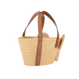 Loewe Elephant Raffia Basket Bag in natural raffia with tan leather handles, gold-tone hardware, and elephant head detail on side.