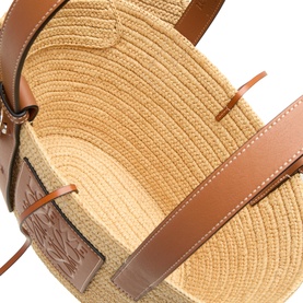 Loewe Elephant Raffia Basket Bag in natural raffia with tan calfskin leather trims, contrast stitching and embossed logo patch detail.