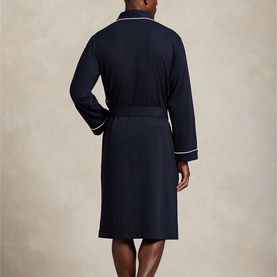 Model wearing Ralph Lauren Pony Player Logo Robe in navy, showing back view with wrap silhouette, self-belt and white contrast piping at cuffs