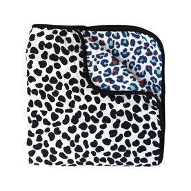 Etta Loves Animal Print Reversible Muslin Blanket, white Dalmatian print side shown, blue leopard print visible on reverse, black trim