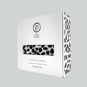 Etta Loves Animal Print Reversible Muslin Blanket in black and white Dalmatian print, shown in branded box packaging