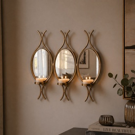 Mindy Browne Claude Mirror Triple Wall Sconce in gold, three oval mirrored frames with tealight holders, mounted on wall