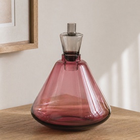 Mindy Browne Glass Vase in purple tinted glass with wide conical base and smoky grey stopper, placed on wooden surface