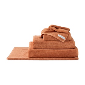 Sheridan Living Textures Towel Maple in orange, 100% cotton, shown as stacked set including bath mat, bath towel, hand towel and face cloth