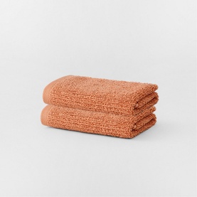 Sheridan Living Textures Towel Maple in orange, two folded cotton towels stacked, textured weave finish