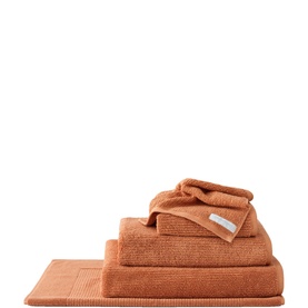 Sheridan Living Textures Towel Maple in orange, 100% cotton, shown as stacked set including bath mat, bath towel, hand towel and face cloth