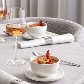 Villeroy & Boch Afina white premium porcelain cup and saucer styled on elegant table setting with rose wine and food