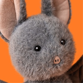 Jellycat Broox Bat 22cm grey plush soft toy, close-up of round fluffy face with black eyes and pink nose