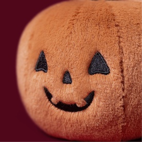 Jellycat Ooky Jack O Lantern 10cm orange plush pumpkin soft toy with embroidered smiling jack-o'-lantern face, close-up detail shot
