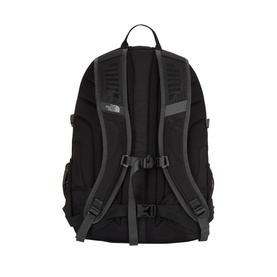 North Face black nylon backpack, rear view showing padded shoulder straps, carry handle, and grey adjustable chest strap with logo patch.