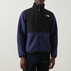 Model wearing North Face Retro Denali Fleece Sweatshirt in Summit Navy/Black, zip-up with contrast panels, chest pockets, styled with dark trousers