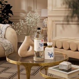 Rituals Fragrance Sticks Refill displayed on a gold coffee table with reed diffuser, ceramic vase, and candle in a styled living room
