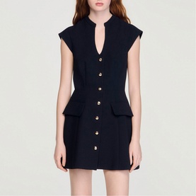 Model wearing Sandro Button Front Mini Knitted Dress in black with V-neckline, gold buttons, cap sleeves and flap pockets