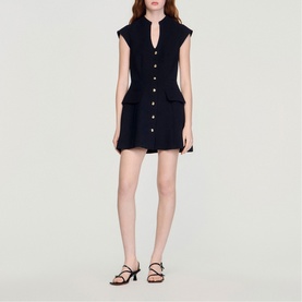 Model wearing Sandro Button Front Mini Knitted Dress in black, sleeveless with V-neckline, front buttons, flap pockets and voluminous skirt. Styled