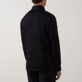Model wearing Boggi Milano Pima Polo Shirt in black, rear view, showing long sleeves, ribbed cuffs and straight hem, styled with black trousers.