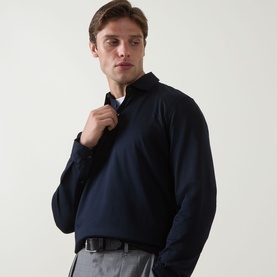 Model wearing Boggi Milano Fine Knit Polo Shirt in navy blue, long sleeves, classic collar, styled with grey trousers and black belt.
