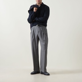 Model wearing Boggi Milano Fine Knit Polo Shirt in navy blue with grey pleated trousers and black leather shoes.