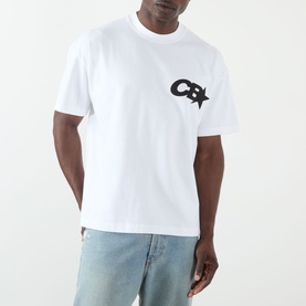 Model wearing Cole Buxton white cotton T-shirt with black CB star logo on chest, styled with light blue jeans