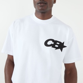 Model wearing Cole Buxton white cotton T-shirt with black CB star logo graphic on chest