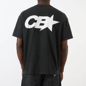 Model wearing Cole Buxton Vintage Black cotton T-shirt, back view showing oversized white CB star graphic print.