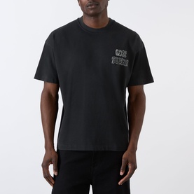 Model wearing Cole Buxton Sportswear Letter Logo T-Shirt in Vintage Black with chest logo print, round neck, short sleeves and dropped shoulders.