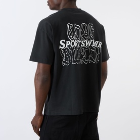 Model wearing Cole Buxton Sportswear Letter Logo T-Shirt in Vintage Black, rear view showing white graphic logo print across back.