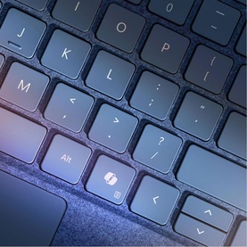 Microsoft Surface Pro Keyboard with Slim Pen Storage in Black, close-up of dark keys including Alt and menu key with blue-toned lighting