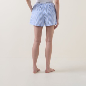 Model wearing Polo nightwear shorts in Hydrangea and Beacon Blue stripe, elasticated logo waistband, 100% cotton, rear view