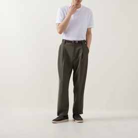 Model wearing Boggi Milano white cotton T-shirt with olive tapered trousers, dark belt and navy espadrilles.